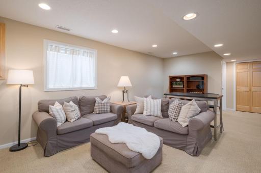 Spacious, bright, and move-in ready. The lower-level family room with recessed lighting and a large sectional setup is the perfect hangout space for family movie nights or weekend gatherings. Comfortable and well finished.