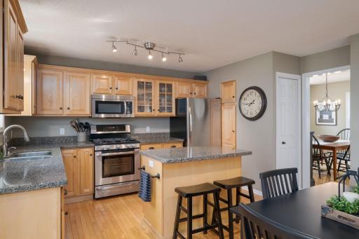 The kitchen center island with bar seating keeps everyone connected whether it's a quick breakfast or an evening cocktail. This is the spot where the day begins and ends well.