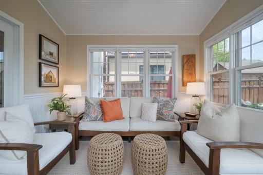 The sun room is pure magic. French doors and an abundance of natural light and a cozy, curated seating arrangement make this the most irresistible spot in the house.