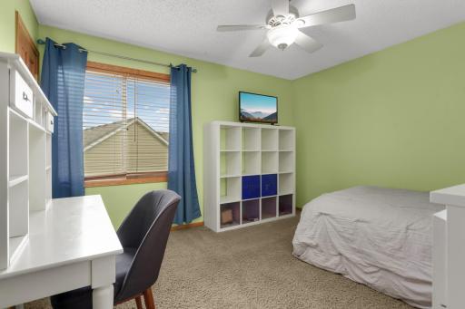 Versatile upper-level third bedroom ideal for family or guests.
