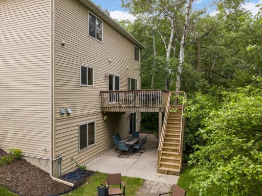 Walk-out design offers multiple outdoor living spaces with deck and patio.