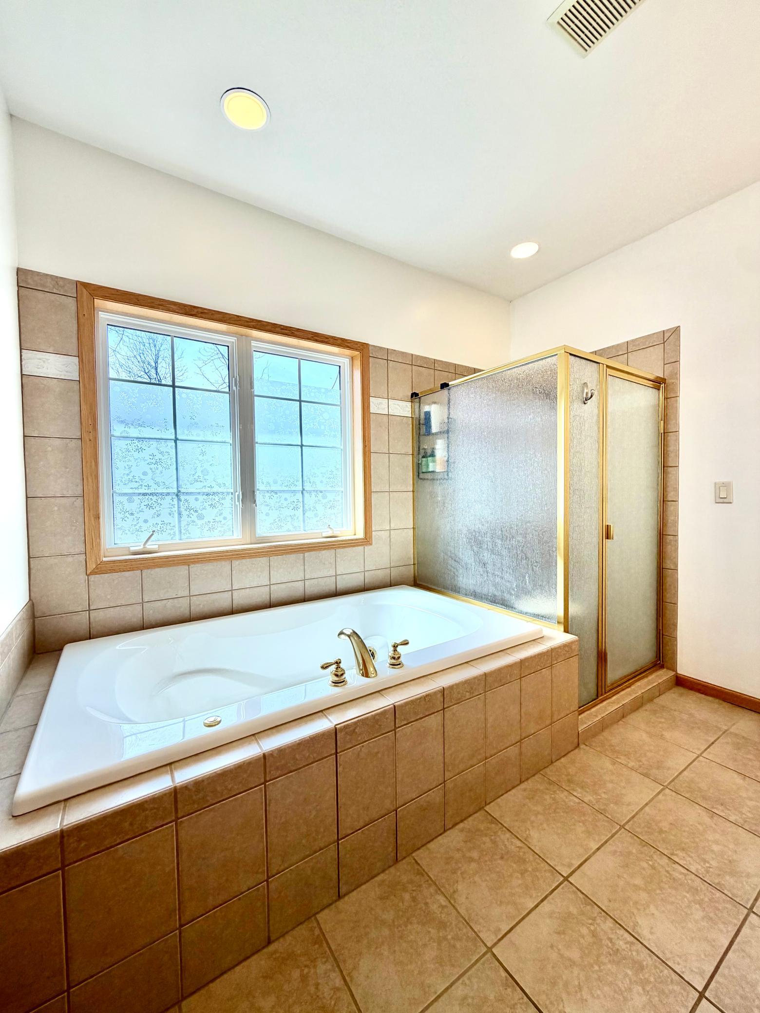 Primary bath with shower and soaking tub.jpeg