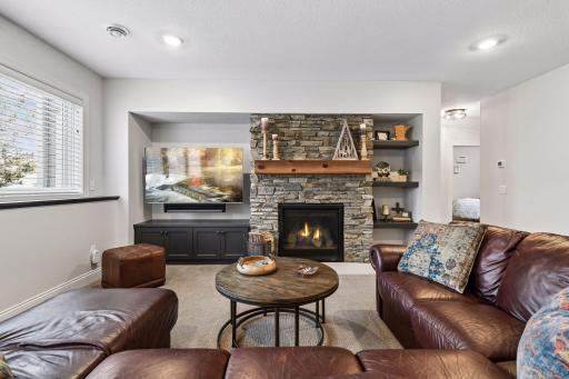 Downstairs, this home brings the FUN! Enjoy a second family room with a gas fireplace and custom built-ins for your TV and components - cheer on your favorite sports teams!