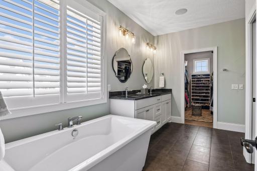 The Primary Bath is worthy of any spa with heated tile flooring and a free-standing soaking bathtub.