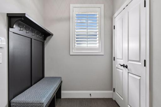 The Mud Room offers a coat closet and built-in custom hall tree with shoe cubbies and coat hooks.