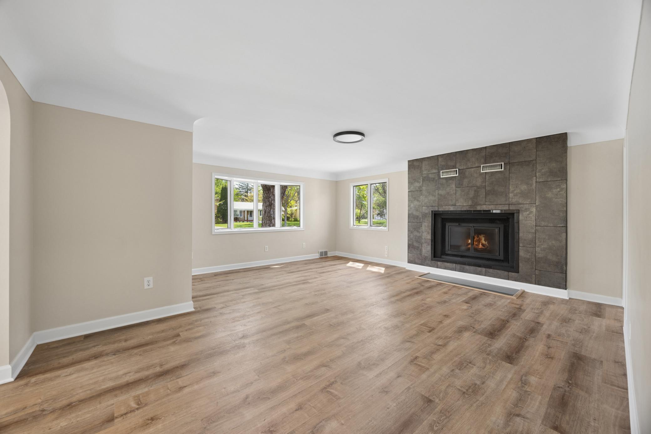 Handsome fireplace new floors, paint & lighting. Move in ready.