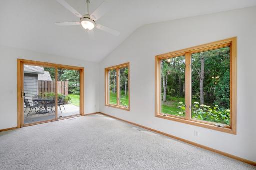 Large lovely sunroom looks onto back yard.