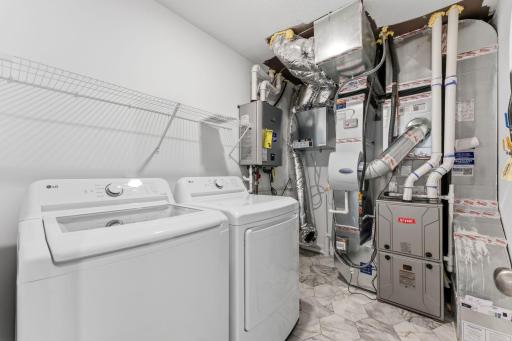 The laundry room features ventilated shelving for your storage needs