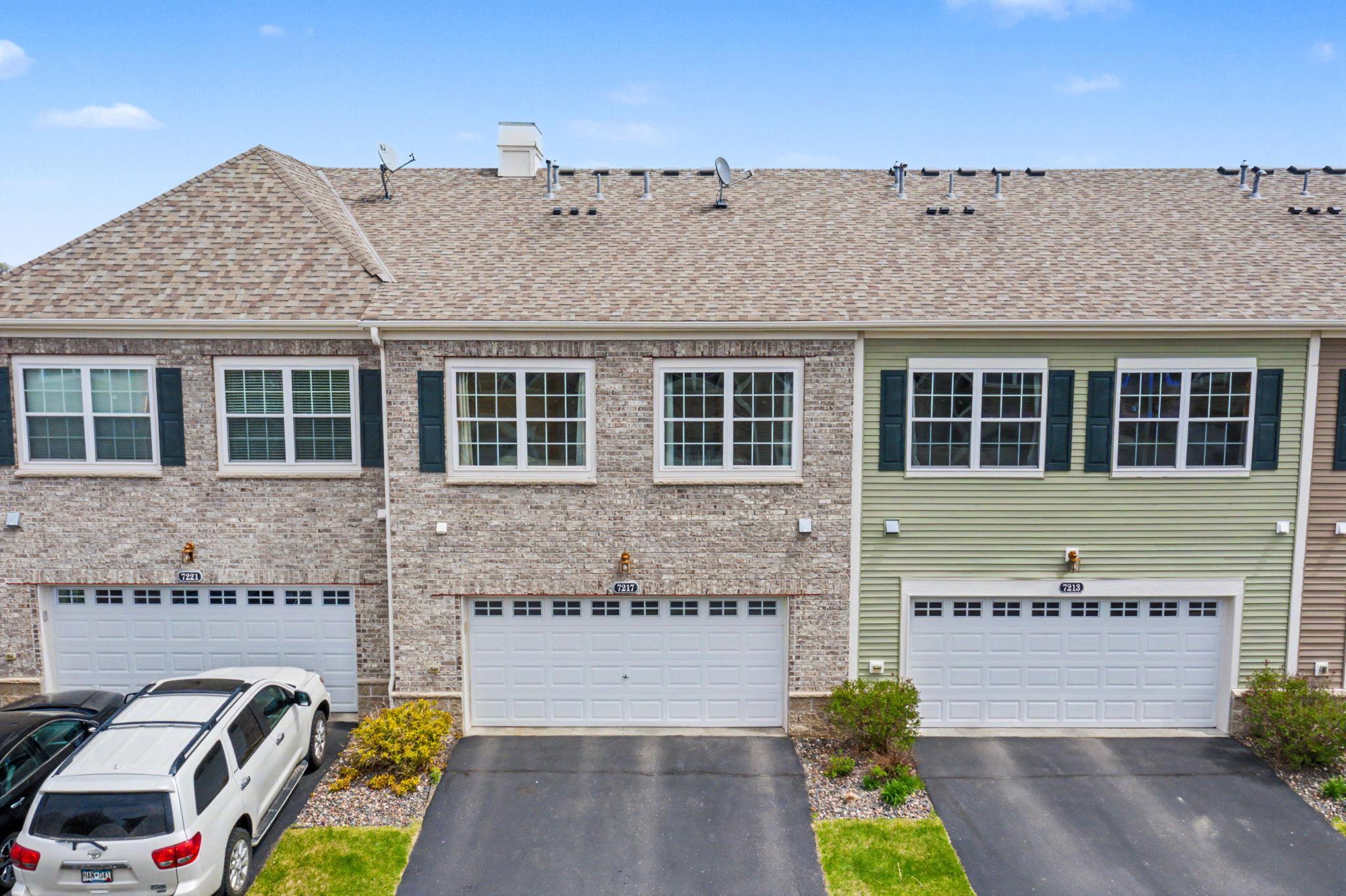 Back of house view with parking and garage