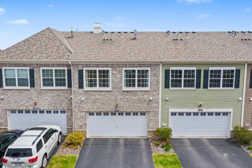 Back of house view with parking and garage