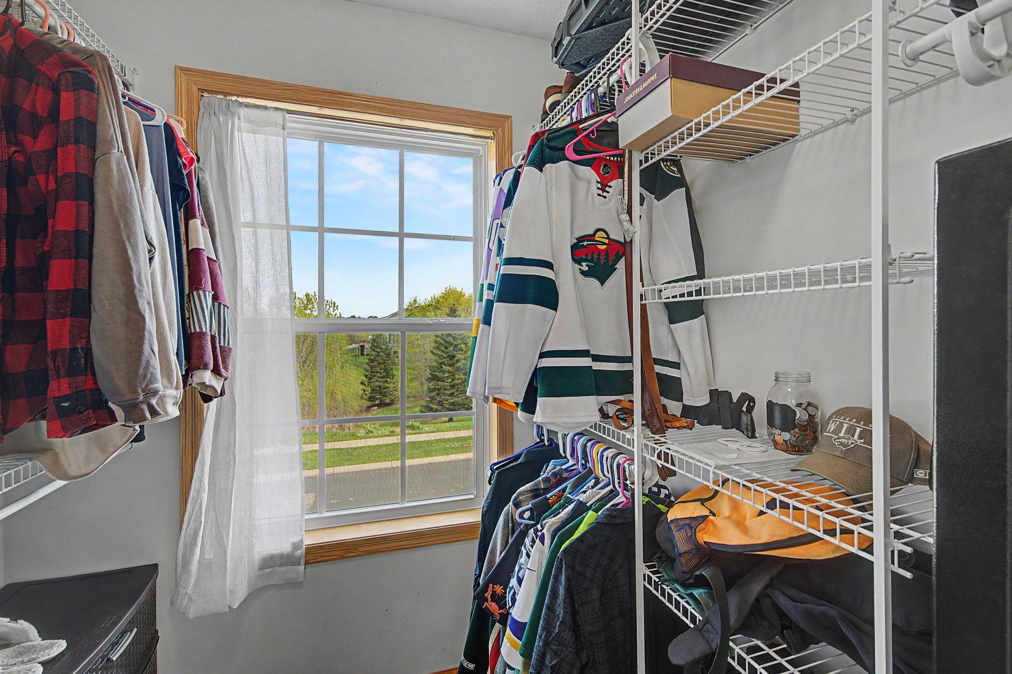 Primary suite walk-in closet with window