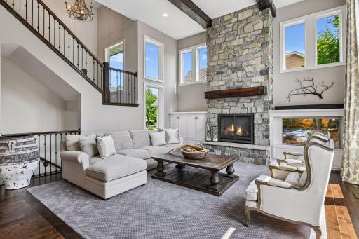 Such a warm and inviting two story great room with real stone floor to ceiling fireplace, knotty alder mantle and beams on ceiling to elevate this space to enjoy by all.