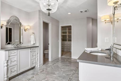 Private stool area and view towards walk in custom closet and walk in tile surround shower. Don't forget the heated floors to enjoy year round.
