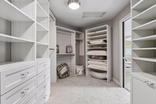 Spacious Primary closet with entry/exit from bathroom and upper laundry room.
