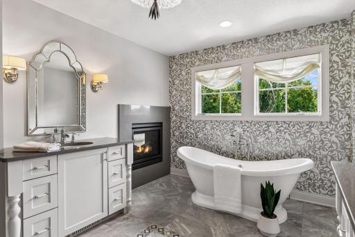 Custom vanities with detailing, double sided fireplace from bedroom to bathroom. Simply stunnin!