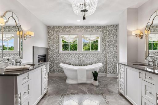 Hello primary bathroom with heated floors, soaking tub, dual vanities adorned in style for today's buyers.