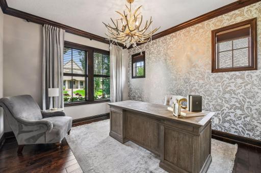 Read wood crown moldings and millwork throughout that elevate the custom features. Home has interior designer draperies included as well.