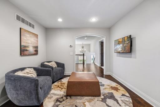 Upper loft area between bedrooms; primary suite, ensuite, and 2 bedrooms that have the pass-through bathroom. Idea spot to hang out, study, work or just relax.