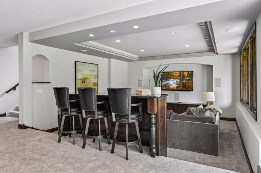 Bar top seating to watch movies or enjoy beverages and popcorn to take it all in. Inlay ceiling with archway areas adding more special features and elevated elegance to the home.