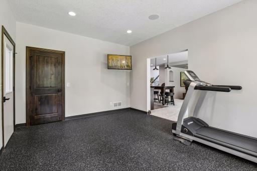 Workout room with closet for storage for all toys that accompany an indoor sport court. Ideal space with TV to run on your tread mill or lift weights all while being entertained by your favorite TV programs.