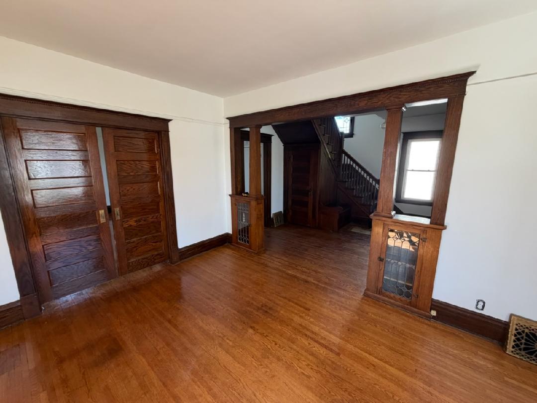 Gorgeous leaded glass built-ins, pocket doors and hardwood floors.