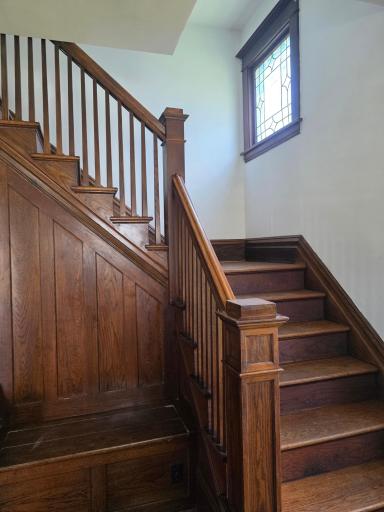 Love this beautiful open staircase with built-in bench.