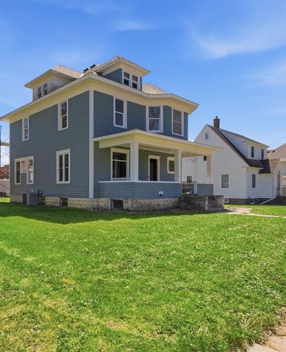 Beautiful home with many leaded glass windows, wonderful front porch with unique bay window front!