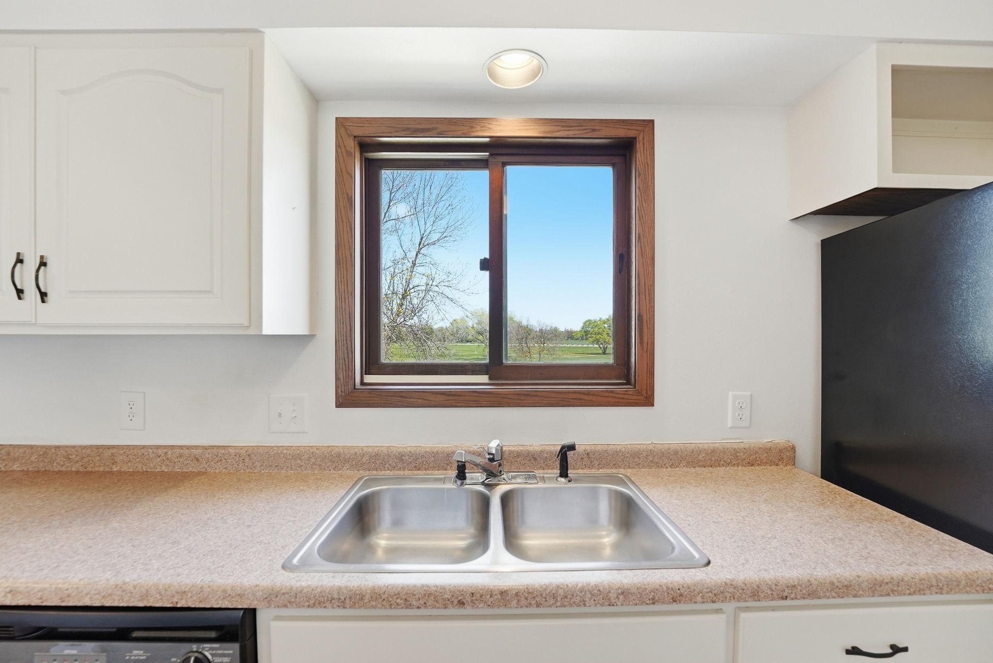 Kitchen features a lookout window.