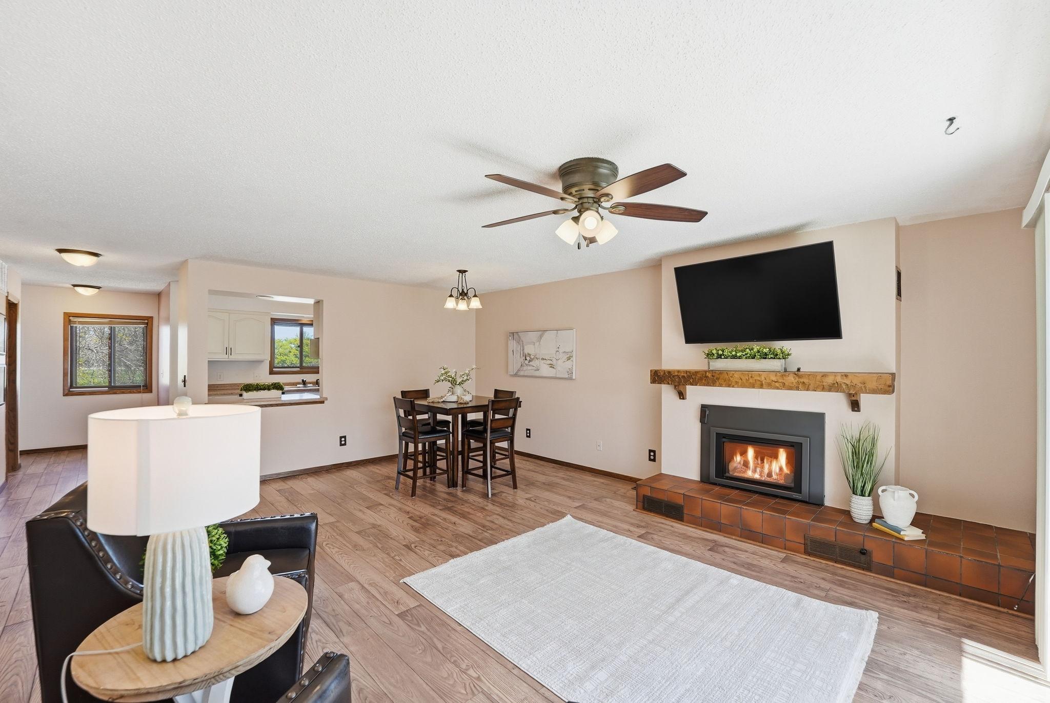 Fireplace becomes a focal point in this well lit living room.