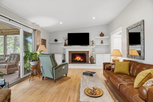 Large living area with charming wood burning fireplace and vaulted ceilings.