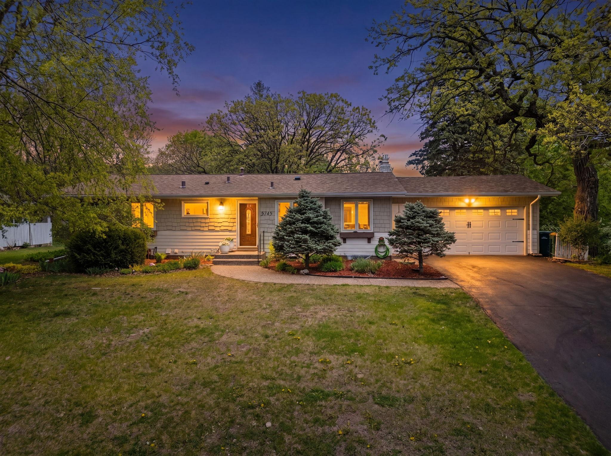 Stunning curb appeal with beautiful landscaping and NEW driveway.