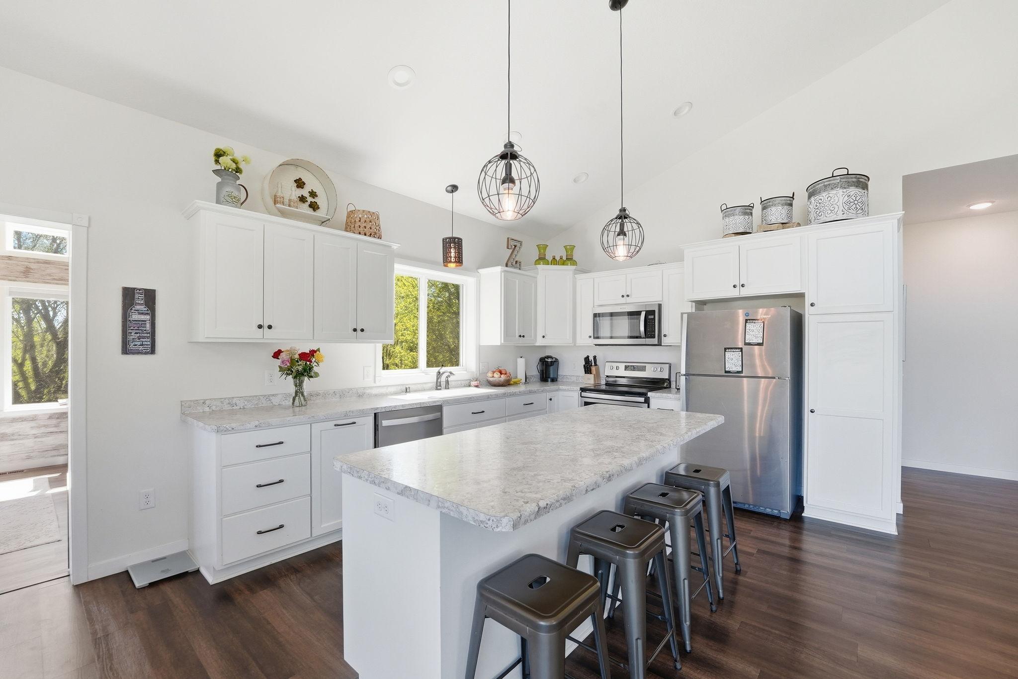 Modern and bright kitchen with stainless steel appliances.
