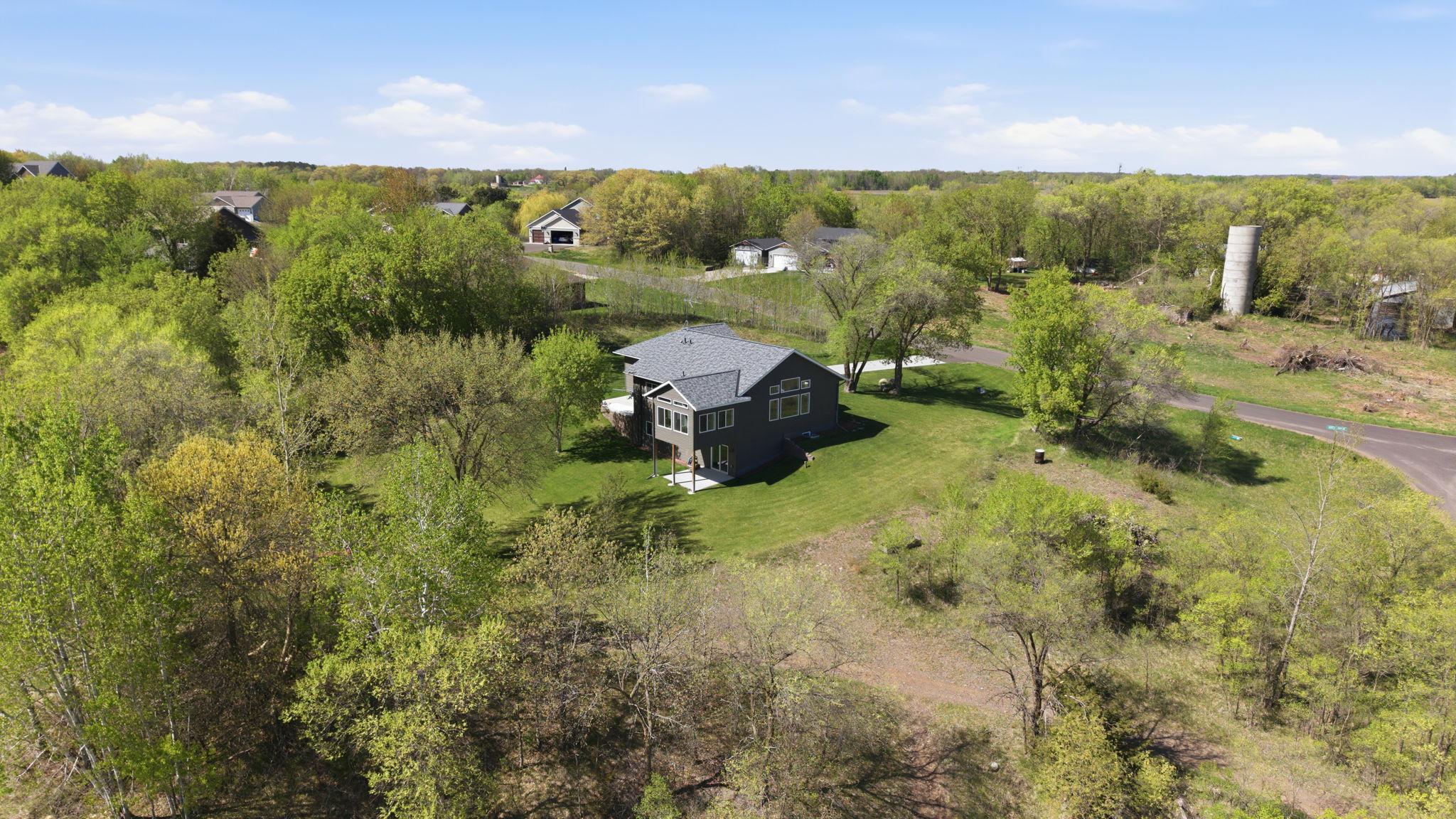 Drone footage provides a full perspective of the home, yard, and surrounding land.