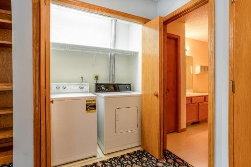Centrally located upper-level laundry closet near the bedrooms and primary bath for convenient everyday ease.