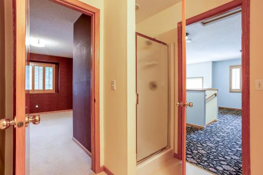 Convenient upper-level bath with walk-in shower, serving the nearby bedrooms and loft.