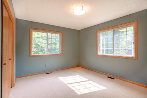 Bright secondary bedroom with large windows, generous closet space, and abundant natural light.
