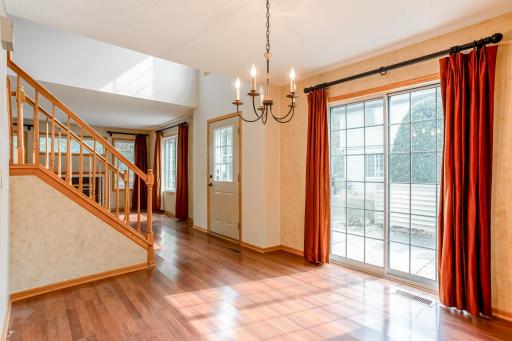 Bright dining area filled with natural light, featuring sliding glass door access to the private patio for effortless indoor-outdoor living.