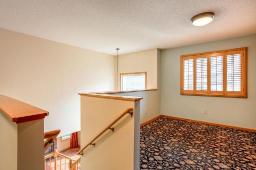 Versatile upper-level loft offers flexible space for a home office, reading nook, media room, or additional living area.