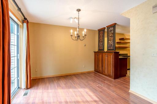 Spacious dining area with plenty of room for entertaining, complemented by custom built-in cabinetry and an open flow to the kitchen.