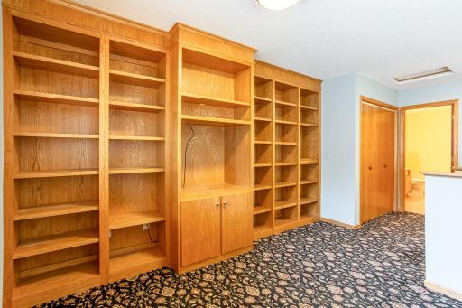 Custom built-in shelving provides exceptional storage and display space while adding character to the upper-level loft.