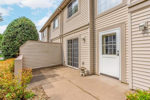Convenient walkout patio with sliding glass door access creates a seamless connection between indoor and outdoor living.