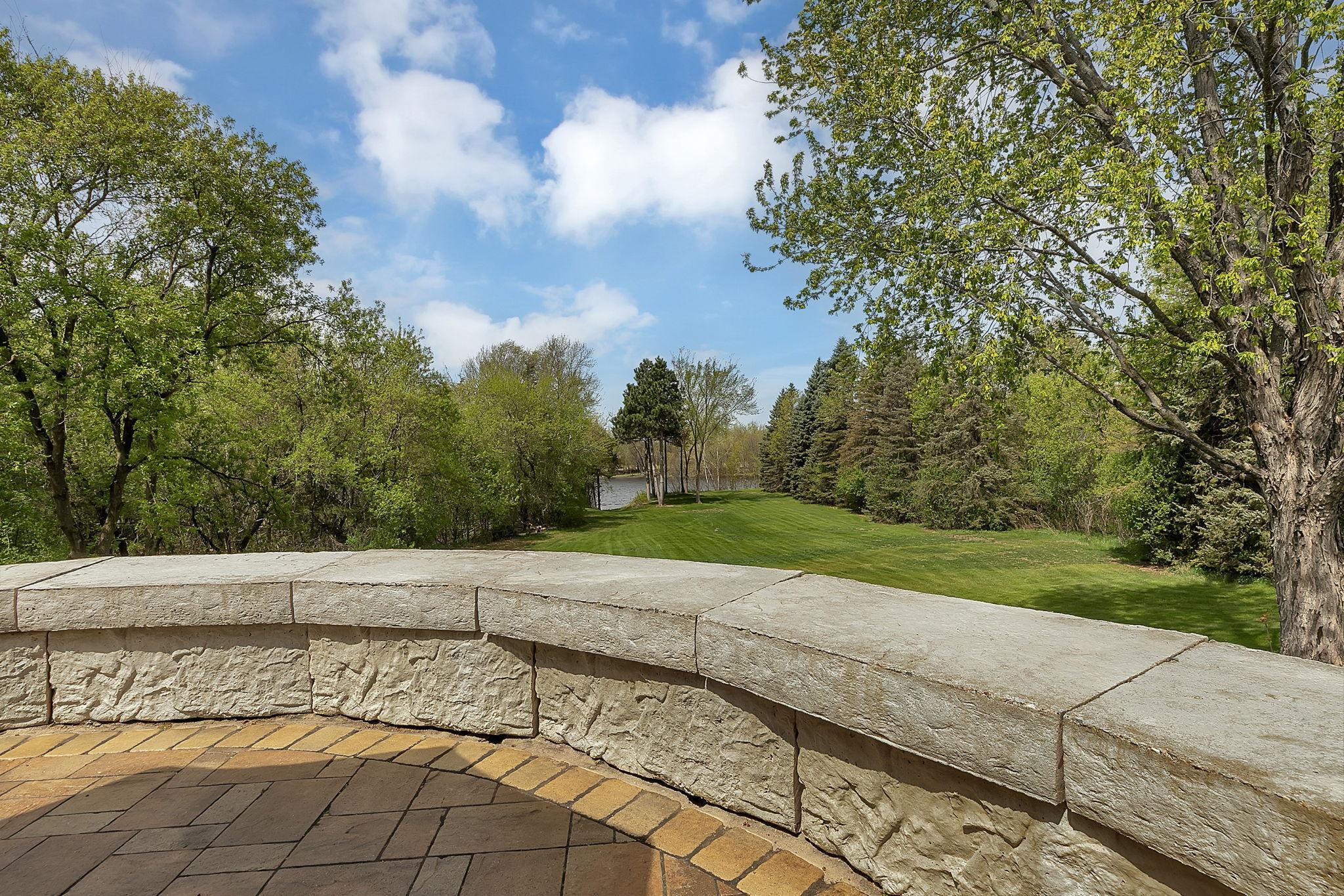 Patio overlooks expansive back yard.