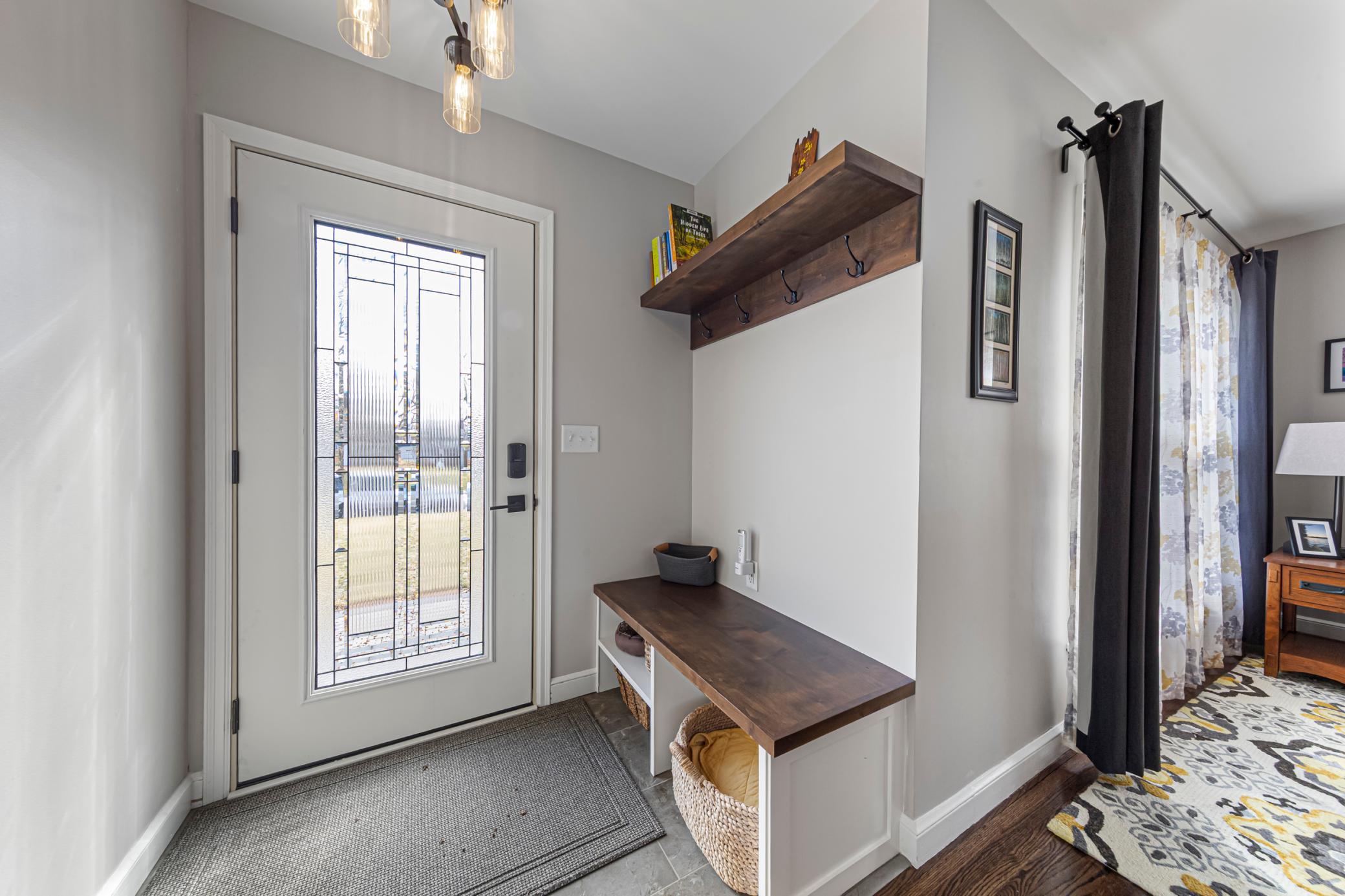 Foyer has built-in bench with storage