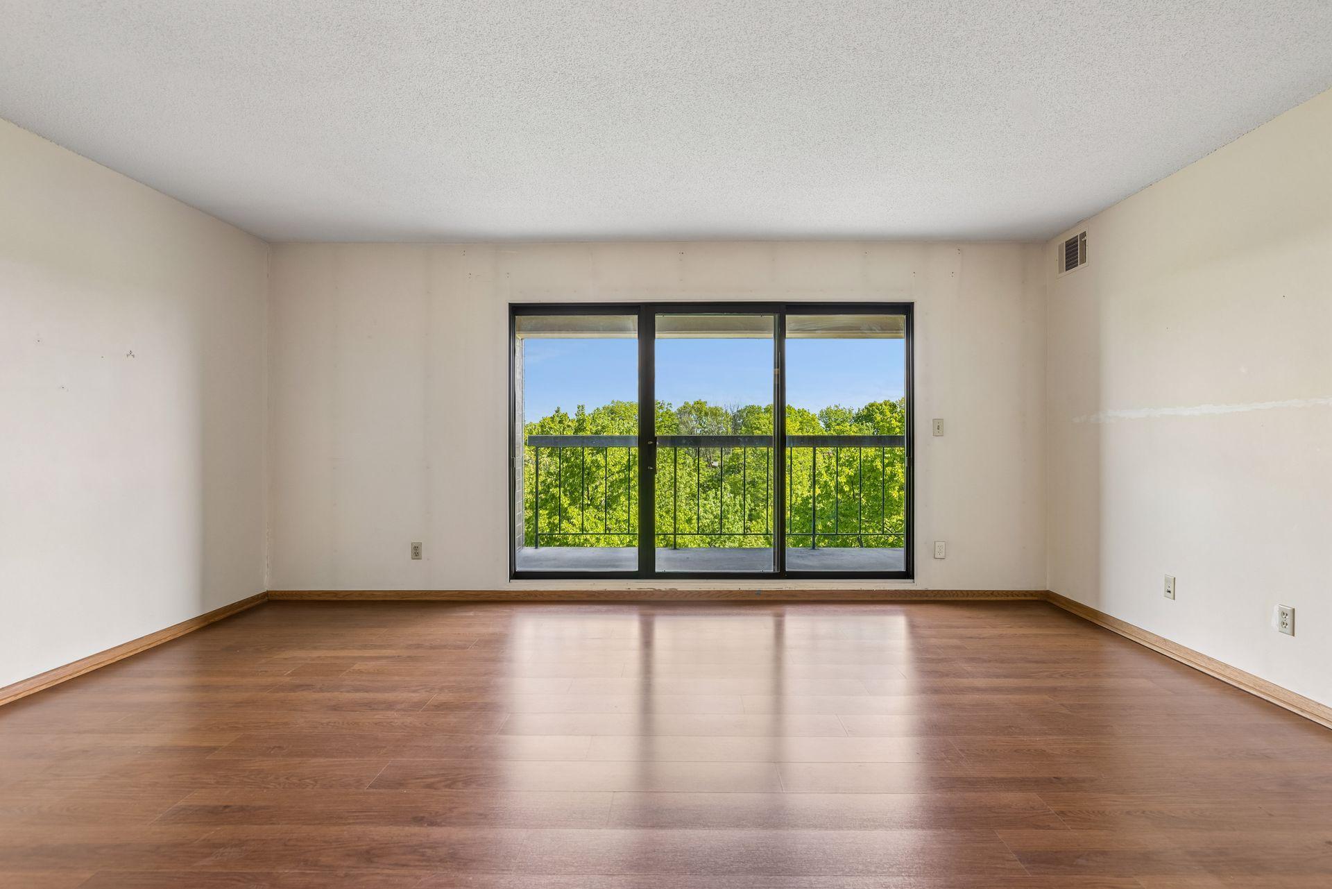 Nice size living room with incredible tree top views.