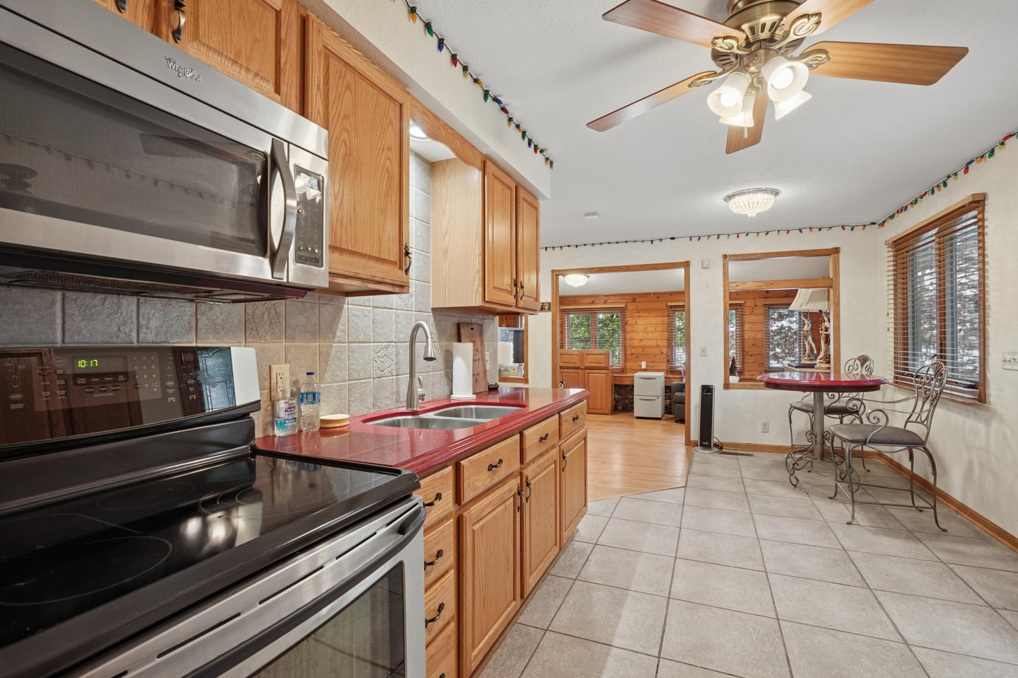 Kitchen features stainless appliances and quartz countertops with a matching round dining table.