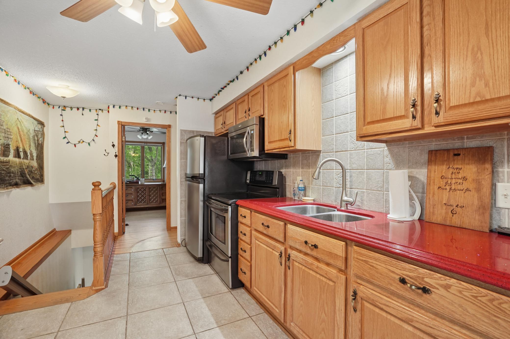 Another view of the kitchen and a peek into one of the two main floor bedrooms.