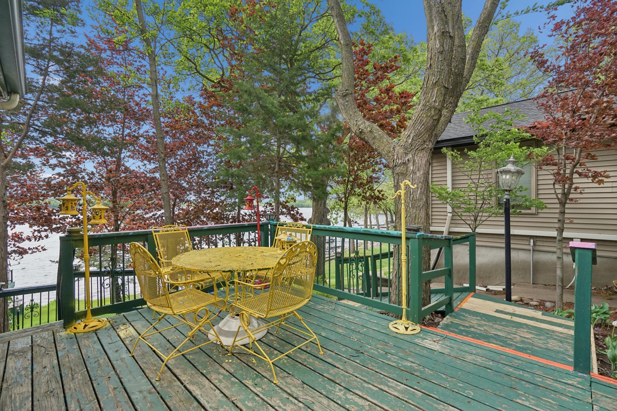This deck, off the kitchen, overlooks the lakeside yard and boathouse.