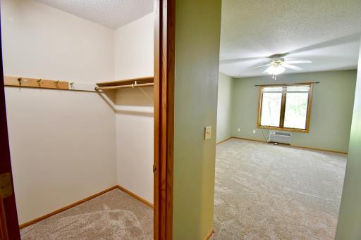 The first of two walk in closets in the primary bedroom isjust inside the door on the left