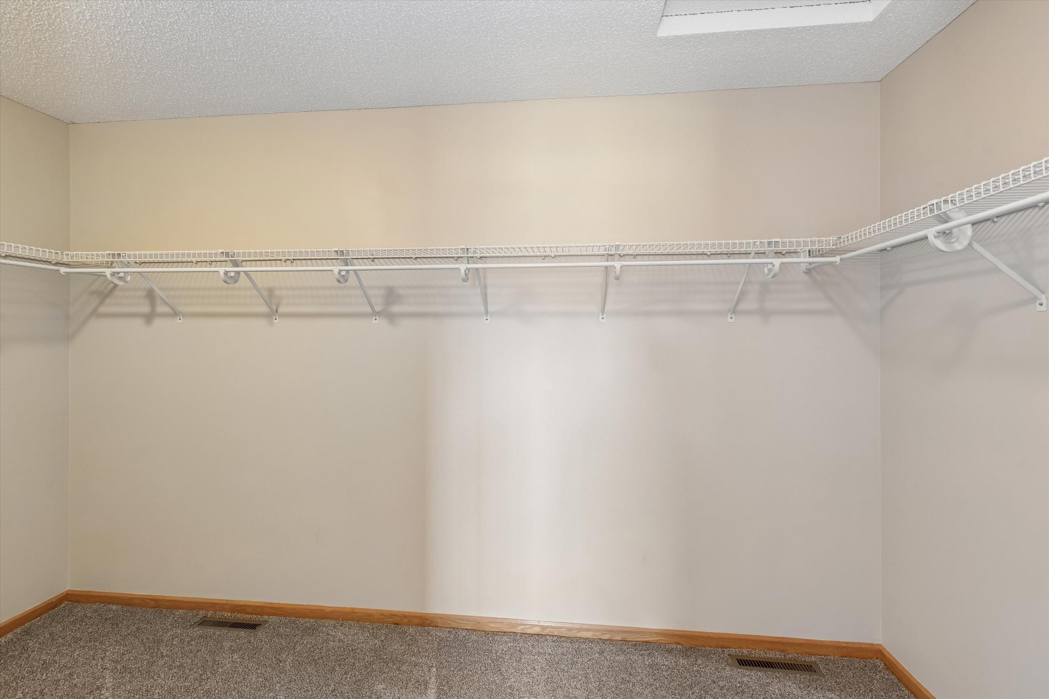 Primary bedroom walk-in closet