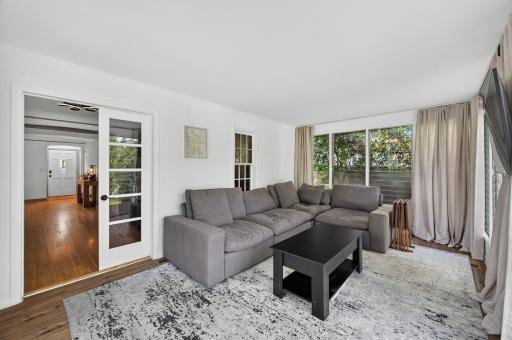 A bright and versatile space for morning coffee, reading, or year-round relaxation.